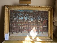 Front view of framed painting showing entire artwork and picture light