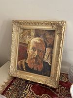 Framed oil portrait leaning on surface