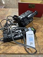 Camcorder with charger, battery, remote, and cables on table
