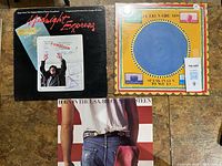 Front covers of three vinyl LPs: Midnight Express soundtrack, Talking Heads Speaking In Tongues, Bruce Springsteen Born In The U.S.A.