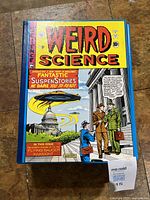 Front cover of one hardcover showing Weird Science artwork