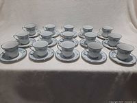 Front view showing all 15 cup-saucer sets