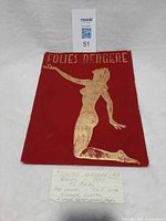 Front cover showing red velvet material and gold silhouette with title