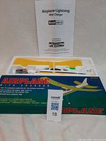 Box with foam tray showing wing, fuselage, charger, manual