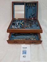 Overall view of open jewelry box with drawers and contents