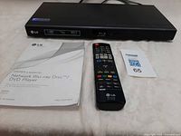 Player, remote and manual laid out together