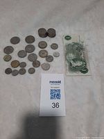 Group shot showing all coins laid out, stacks and £1 note