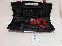 Saw in open carrying case showing full tool and cord