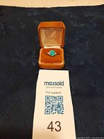 Ring in box with lot card visible