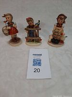 Three Hummel figurines front view