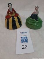 Both porcelain lady dresser dishes side by side