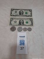 Front of both bills and obverse of all four coins