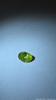 Oval chartreuse sphene gemstone front view