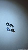 Four round sapphires under focused light