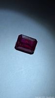 Front view of emerald-cut ruby showing color and shape