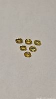All six yellow oval sapphires on neutral background