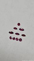 Group of nine faceted rubies on white background