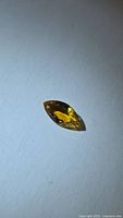 Marquise-cut vivid yellow tourmaline on white background