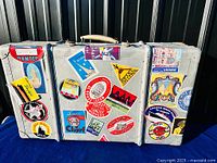 Front view of aluminum suitcase trunk showing travel labels