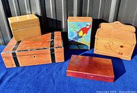 Five wooden boxes arranged on blue cloth