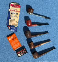 Group shot showing five pipes, Byeco pipe cleaners pack, Brigham filter box, charcoal filter box