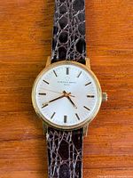 Front view showing dial, hands, markers, strap texture