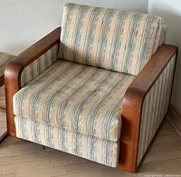 Front and side view of teak armchair showing fabric pattern and frame details