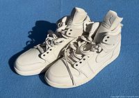Pair of white Nike Air Jordan 1 Retro High sneakers angled view