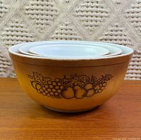 three nested Pyrex Old Orchard bowls showing exterior color and fruit pattern