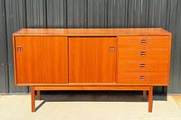 Full front view of teak sideboard showing sliding doors and drawers