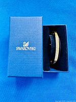 Closed blue Swarovski box with bracelet partially visible