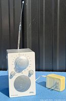 Front view of Tivoli Audio radio with antenna extended and power adapter