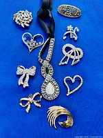 Group shot of all jewelry pieces on blue background