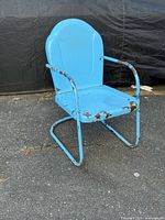 Front view of blue clamshell metal chair