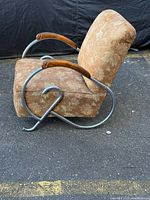 Side view showing chrome loop frame, wood arm, upholstery