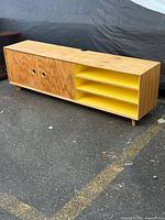 Full view of credenza front showing doors and yellow shelves