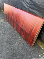 Front angled view of rosewood veneer queen headboard showing wood grain and size