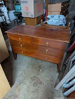 Front and top view of mahogany dresser showing six drawers and brass hardware