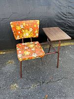 Front view of telephone table showing floral chair, side table and magazine rack