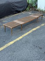 Bench fully extended showing slatted top and six tapered legs