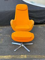 Front view of orange high-back swivel chair and footstool on aluminum bases