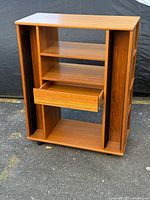 Front view showing shelves, drawer, CD racks, casters