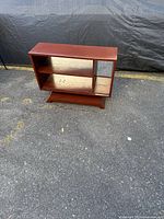 Front view showing overall structure, shelves and pedestal base