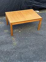 Overall view of rectangular teak side table outdoors