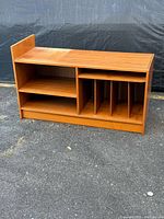 Front view of teak audio cabinet showing shelves and record dividers