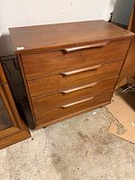 Front view of walnut four-drawer dresser