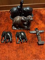 All five carved wood items arranged on carpet