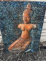 Front view of framed artwork showing Buddha figure and background text