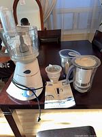 Overall view of motor base with attached Super Extractor jar, additional jars, manual