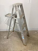 Full view of Werner aluminum step ladder front